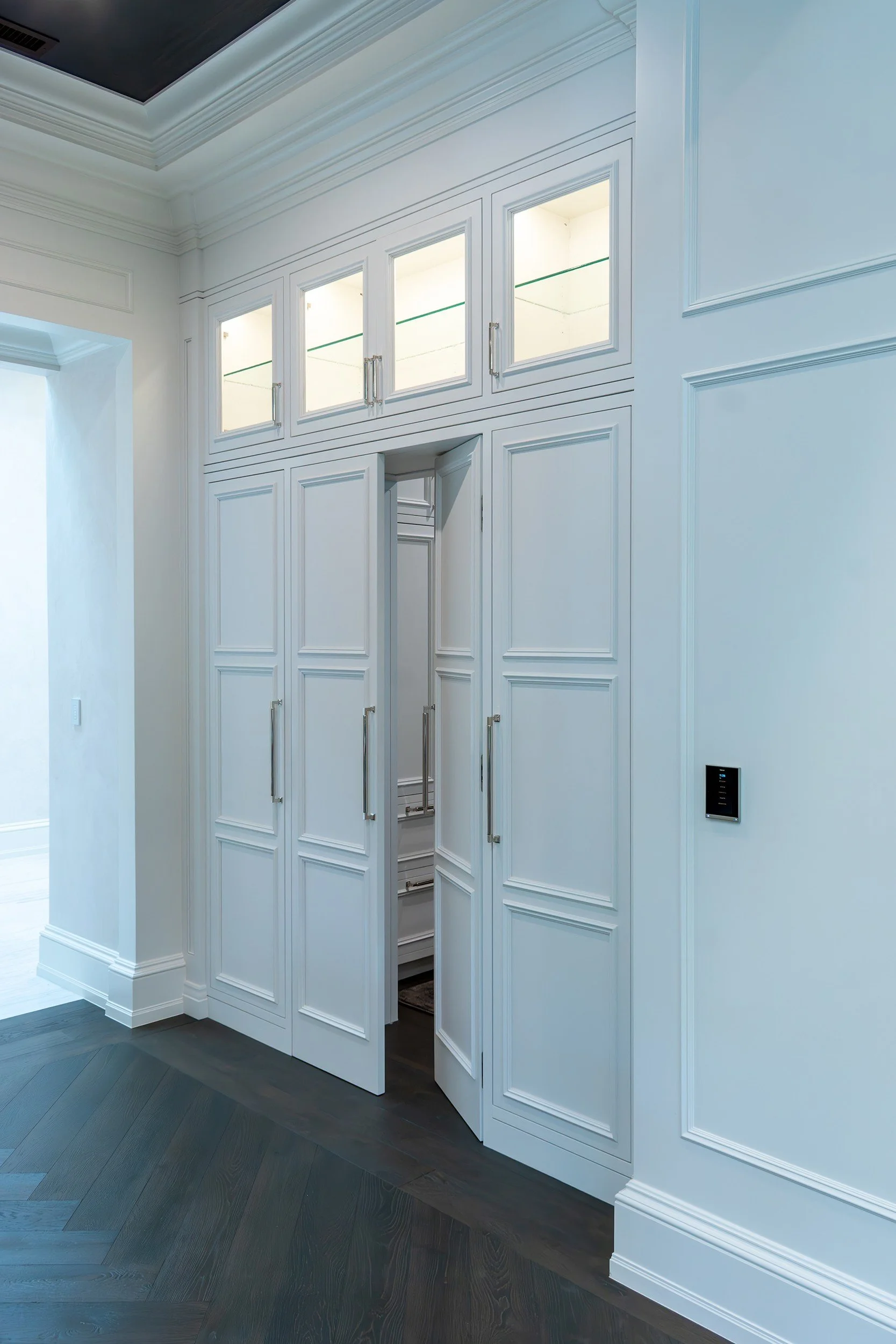 Concealed pantry door within paneled millwork