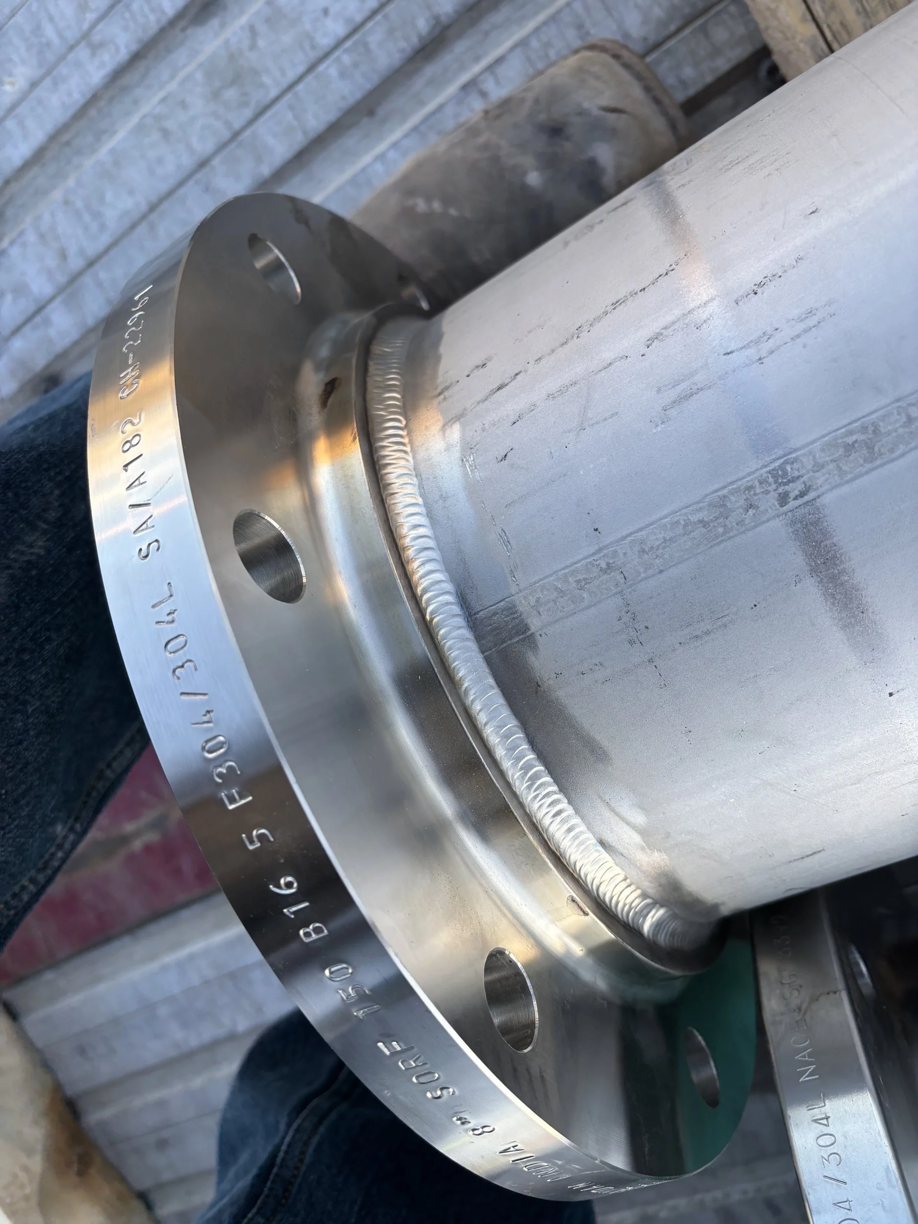Clean TIG weld joining a stainless steel pipe flange