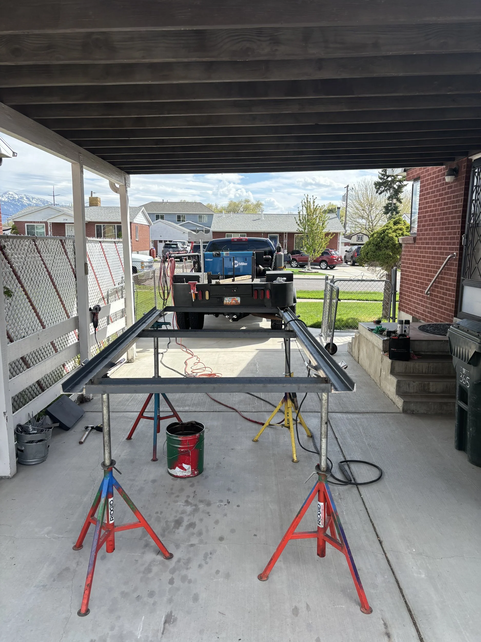 Custom steel trailer frame being fabricated on jack stands