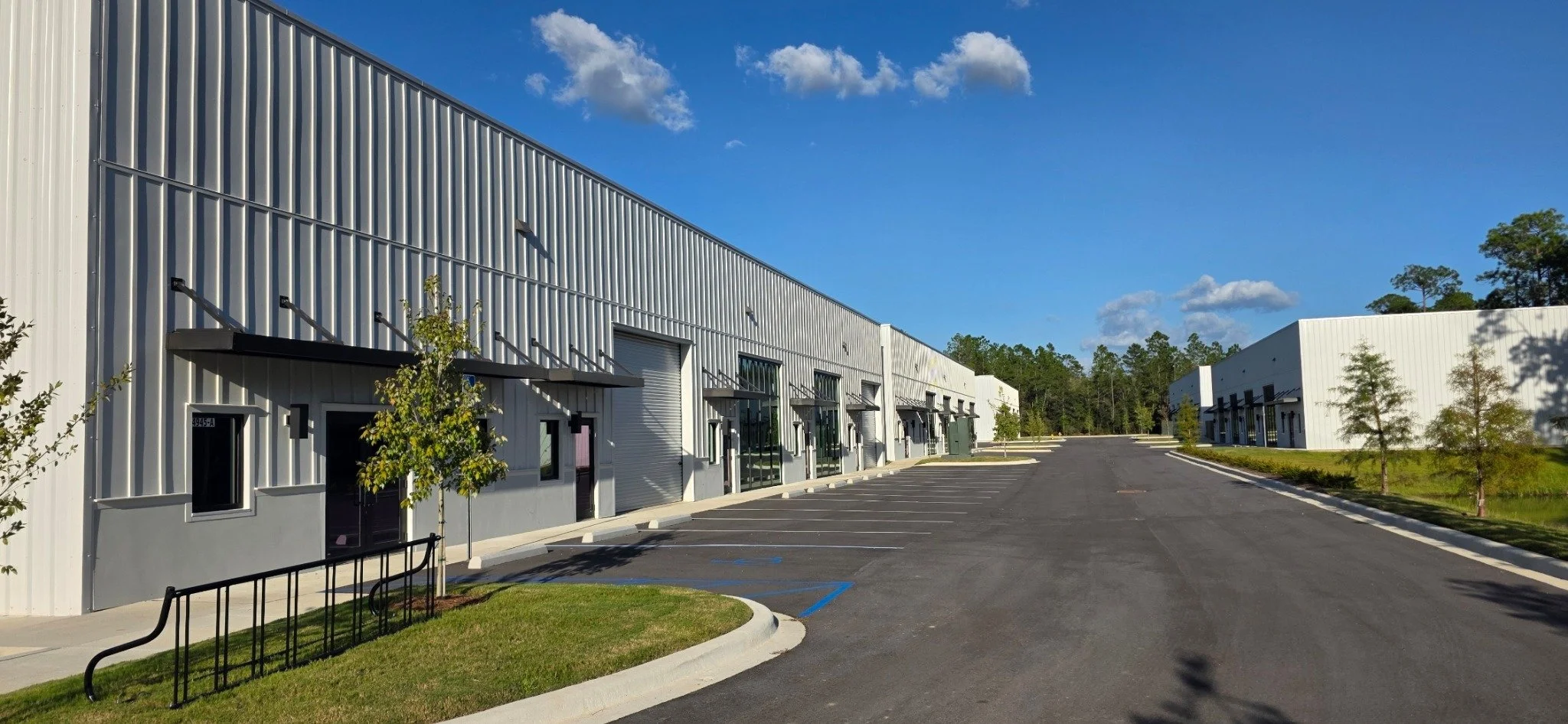 Commercial suites, storefronts, roll-up doors, and parking at RMC Commerce Park in Freeport, Florida