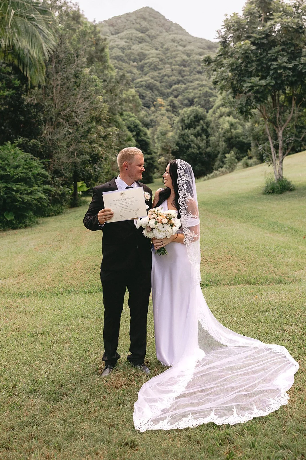 Couple holding their marriage certificate, Kobi and Darren's elopement at Butterfly Lane, Byron Bay hinterland