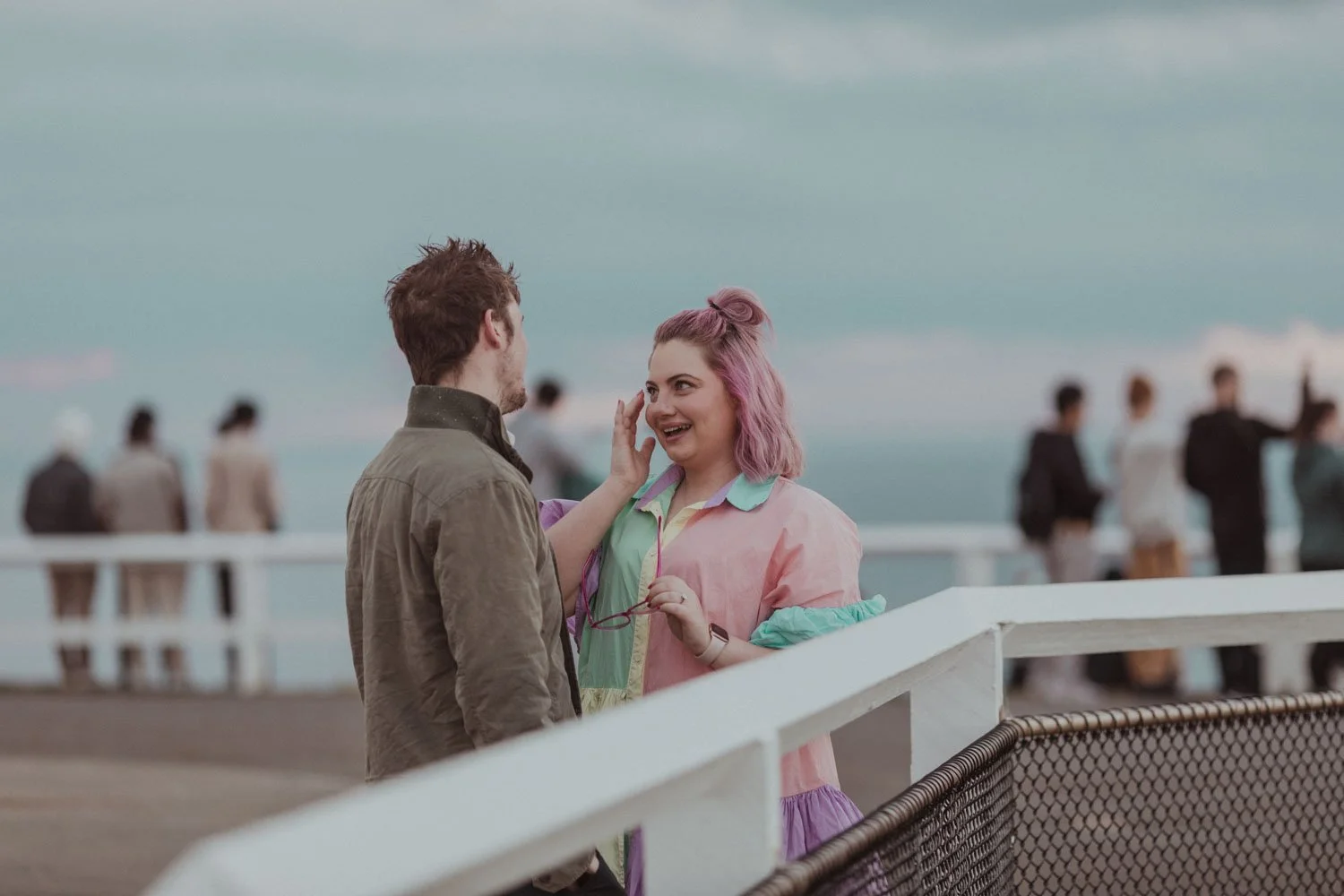 Laughing at the lookout railing moments after a surprise proposal at Cape Byron