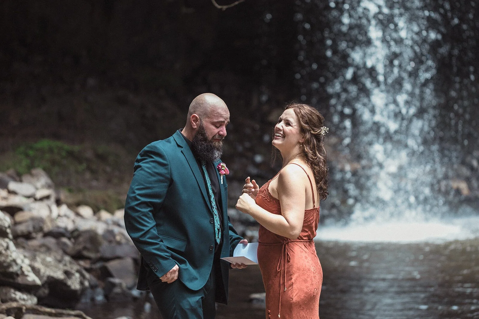 Groom laughing with the bride beside the falls, Sara and Graeme's elopement at Killen Falls, Northern Rivers