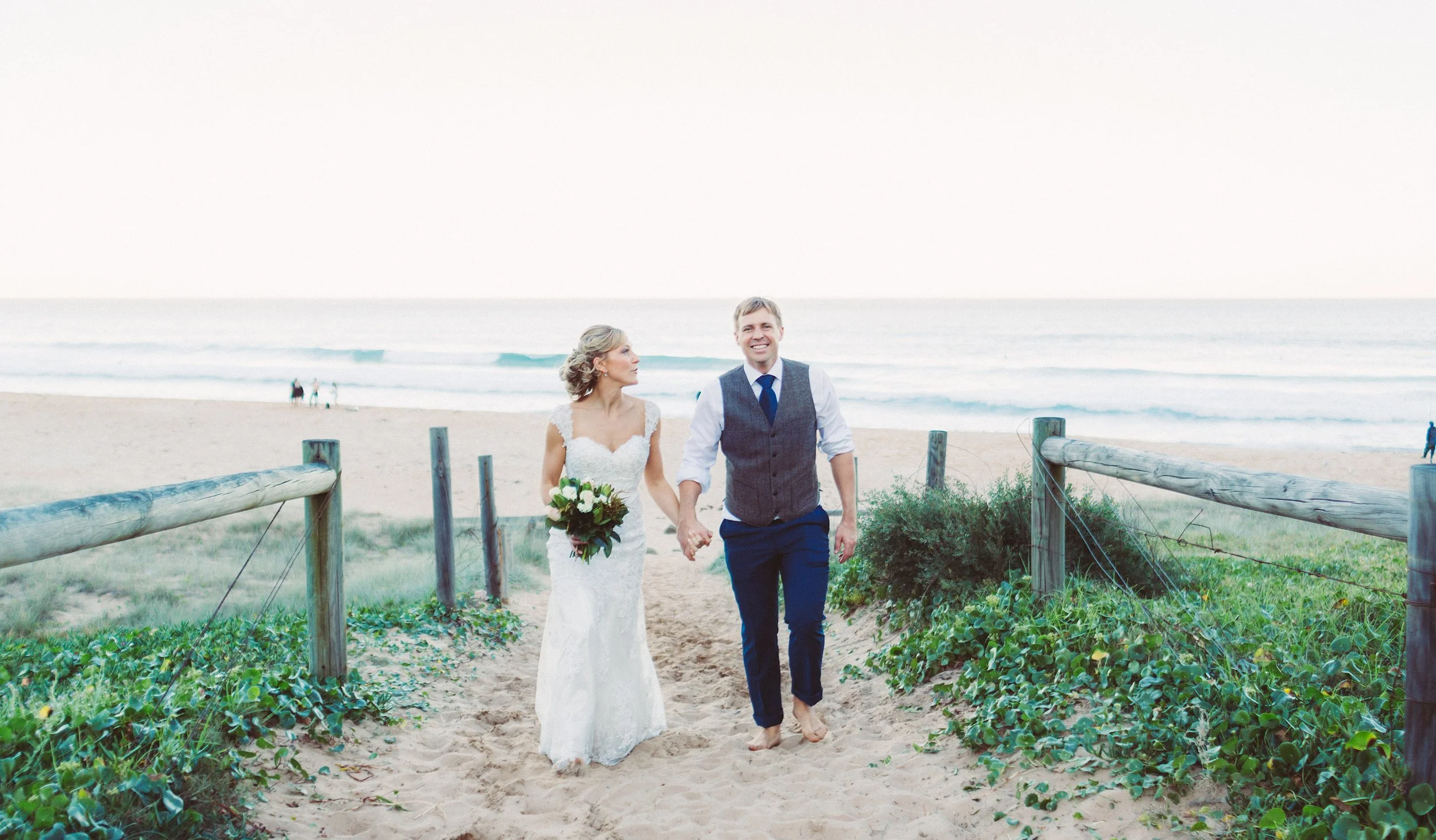 Bride and groom walking up the dune track at Garie Beach, Royal National Park