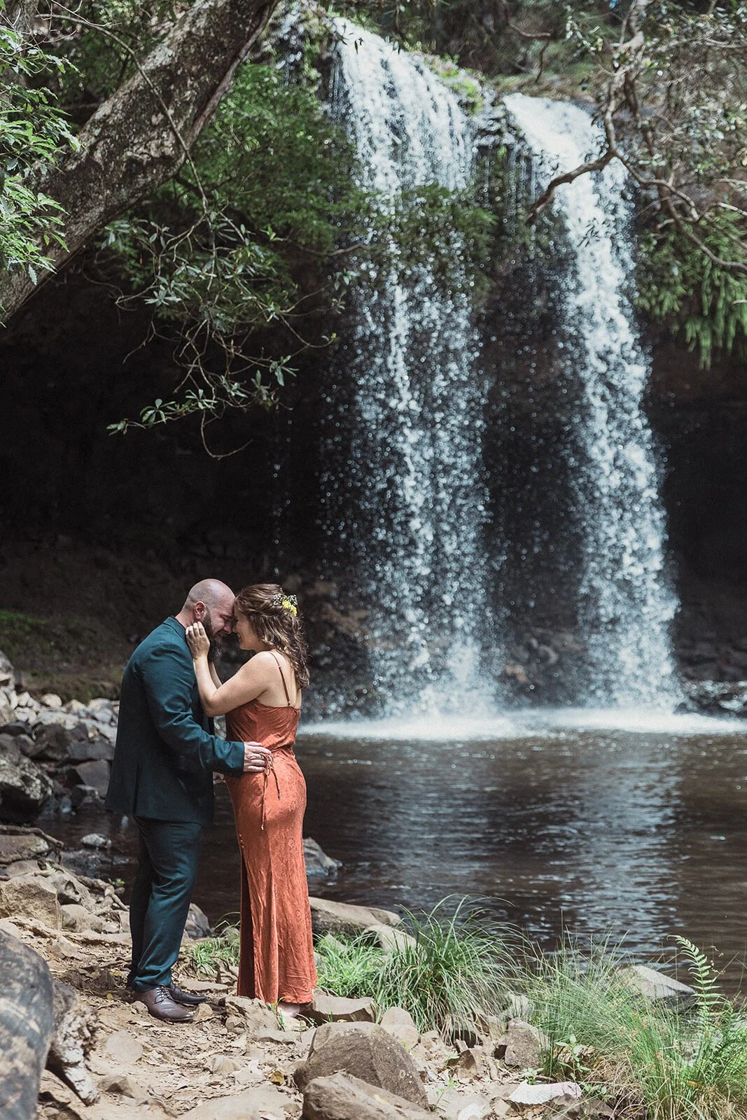 Couple kissing beneath the waterfall, Sara and Graeme's elopement at Killen Falls, Northern Rivers