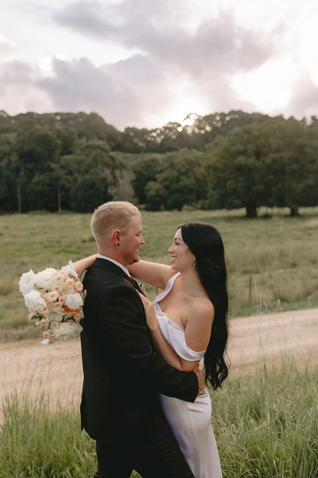 Couple dancing in the paddock at sunset, Kobi and Darren's elopement at Butterfly Lane, Byron Bay hinterland