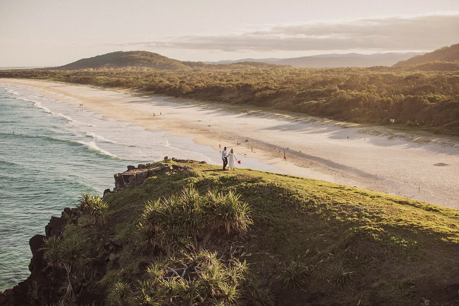 Couple on the grassy headland with a sweeping beach view, Brittany and Mark's elopement at Cabarita Beach, Northern Rivers