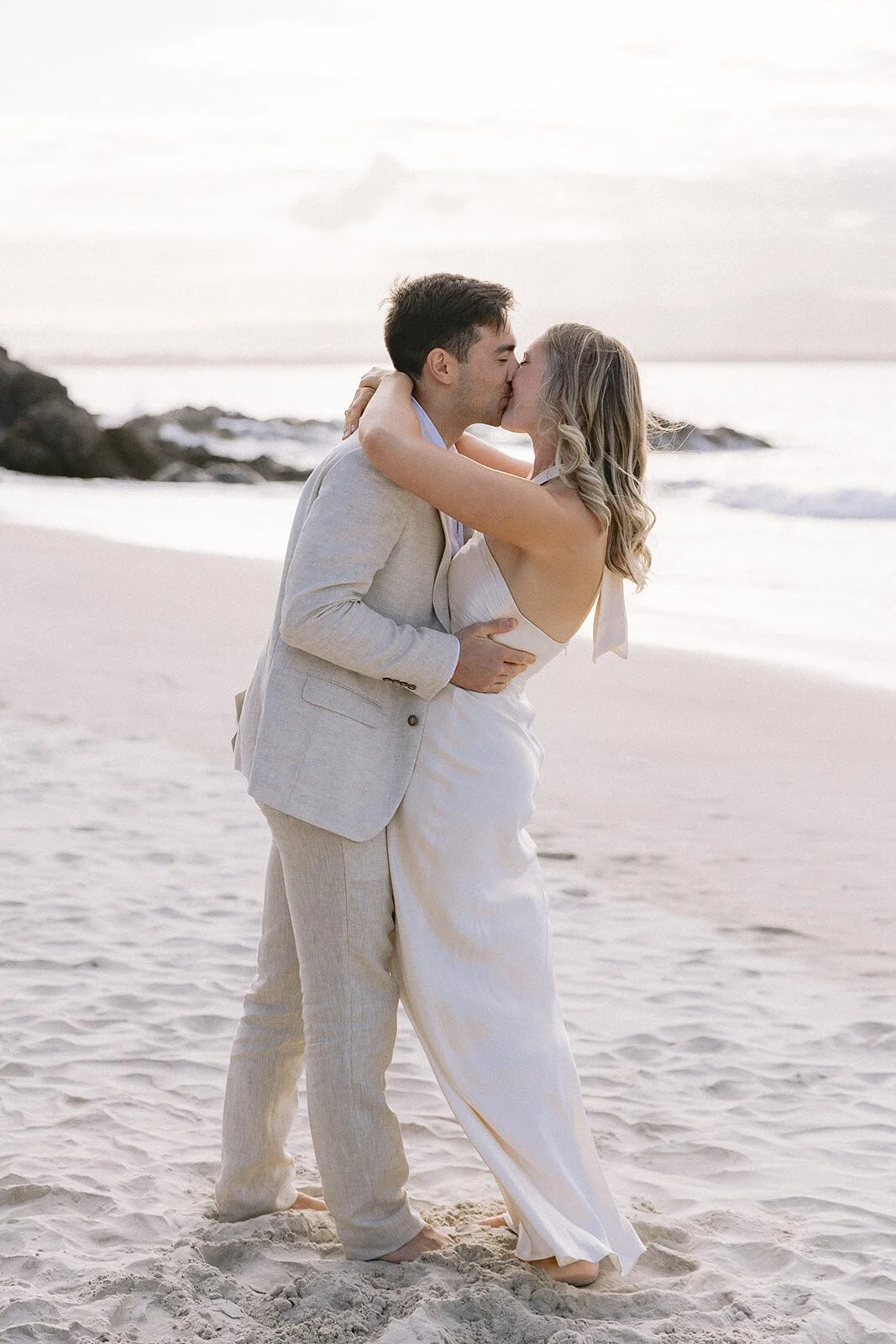 Couple kissing on the sand, Abby and James' elopement at Little Wategos Beach, Byron Bay