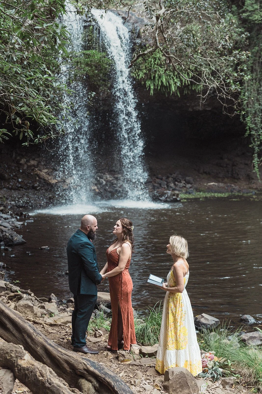 Couple holding hands as the celebrant reads, Sara and Graeme's elopement at Killen Falls, Northern Rivers