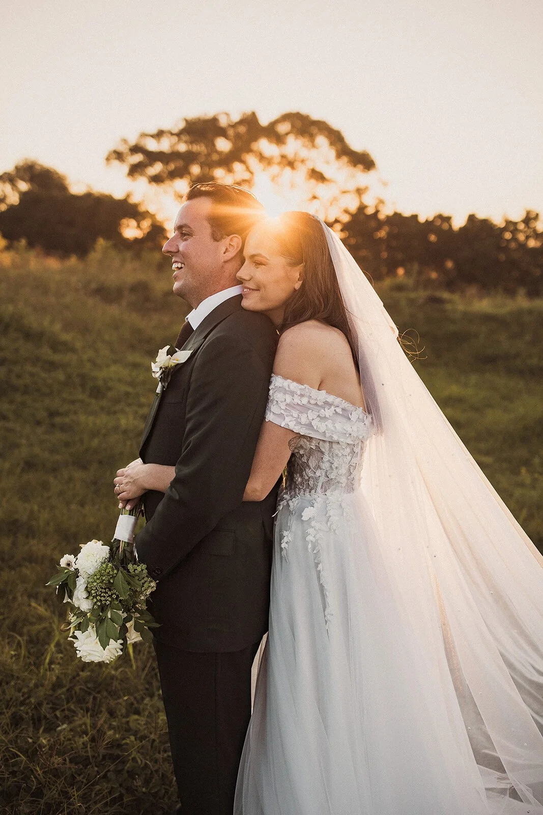Couple laughing in the sunset, Steph and William's wedding at Earth House, Byron Bay