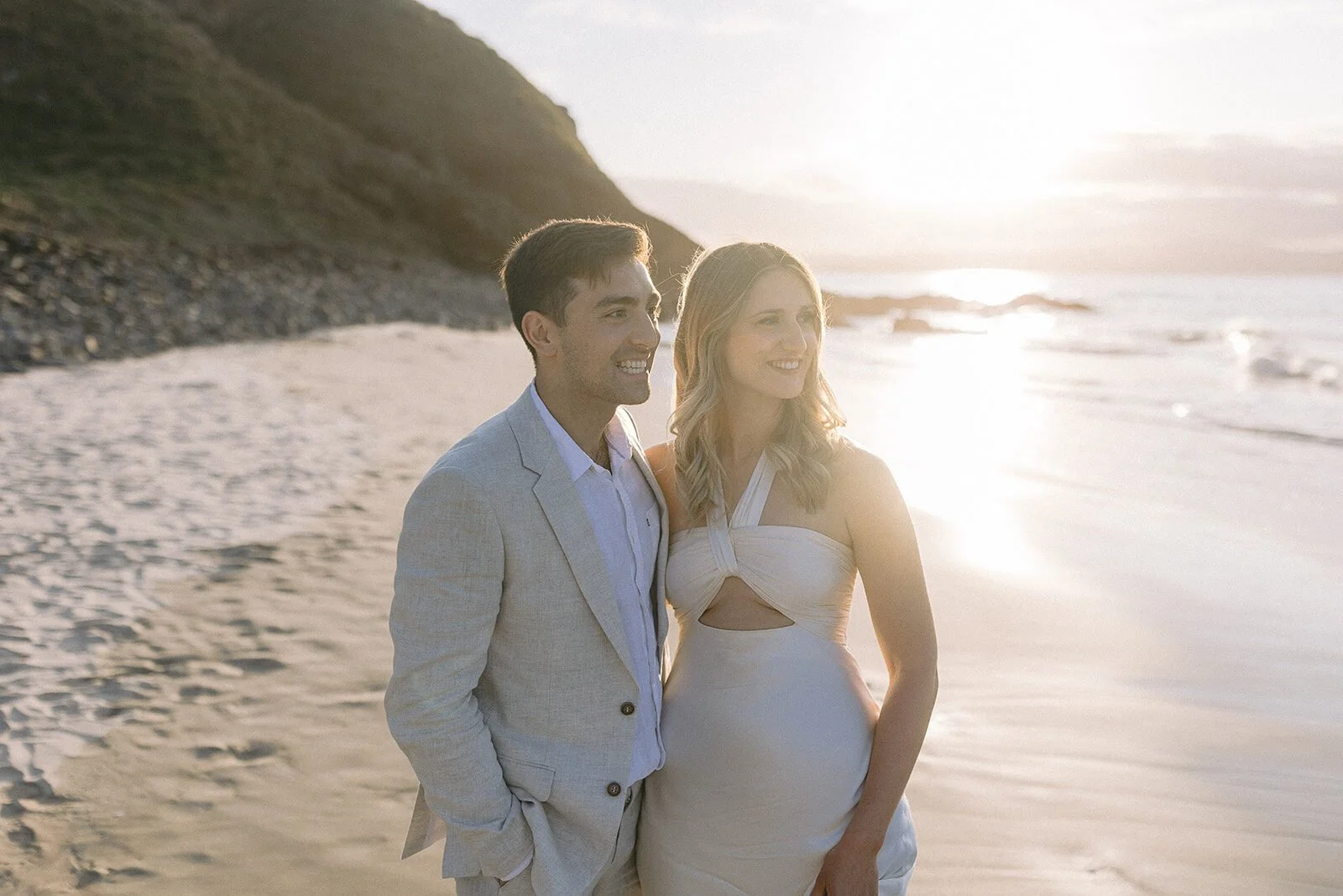 Couple looking out to sea in golden light, Abby and James' elopement at Little Wategos Beach, Byron Bay