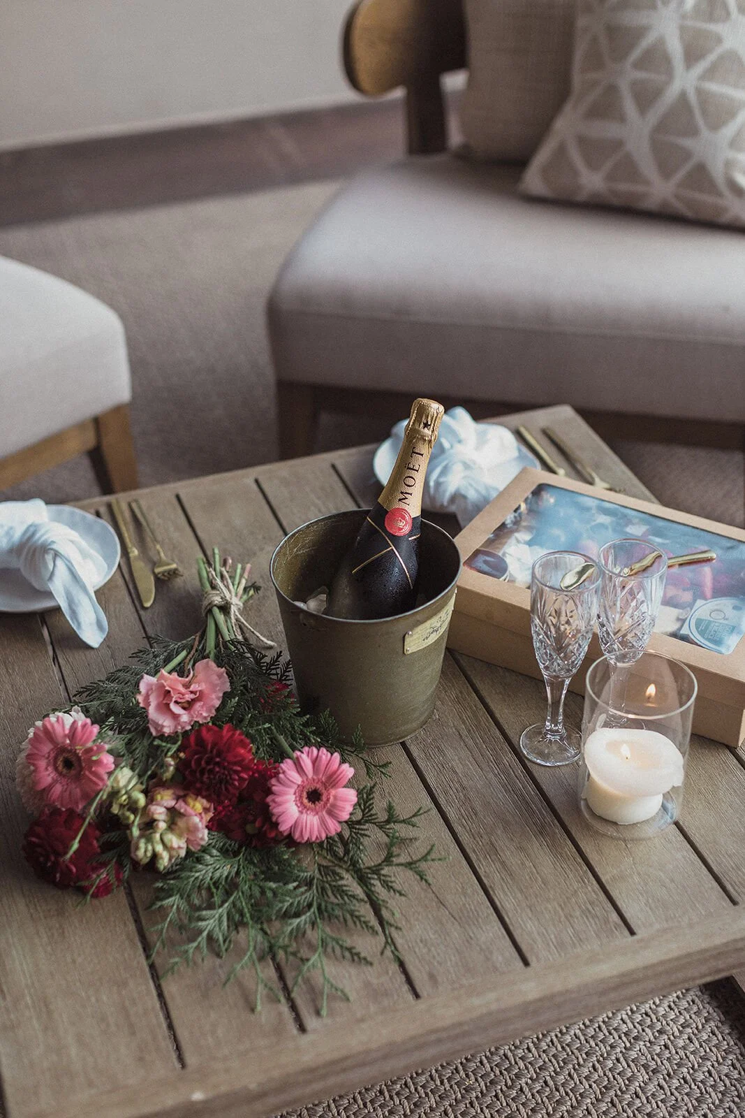 Close detail of the champagne bucket, crystal glasses and flowers on the table, Ben and Chloe's marriage proposal in Byron Bay