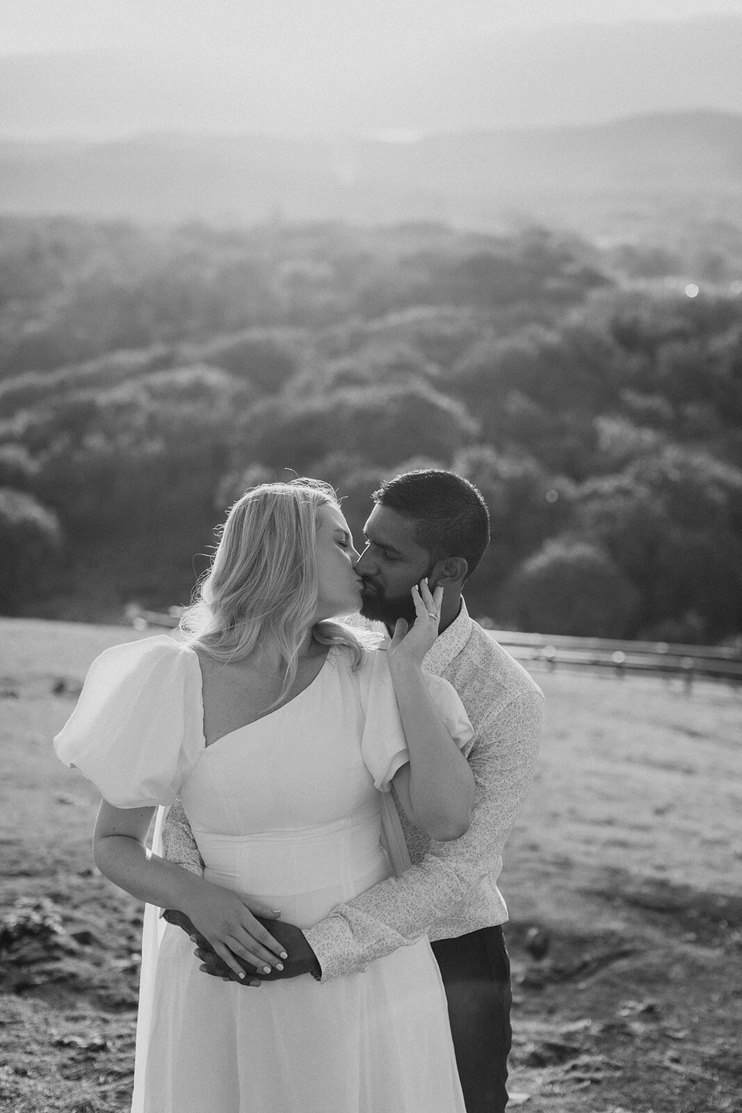 Black and white of the couple kissing with the coastline behind, Brittany and Mark's elopement at Cabarita Beach, Northern Rivers