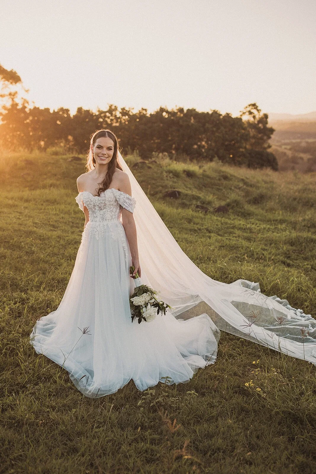 Bride smiling with her veil trailing, Steph and William's wedding at Earth House, Byron Bay