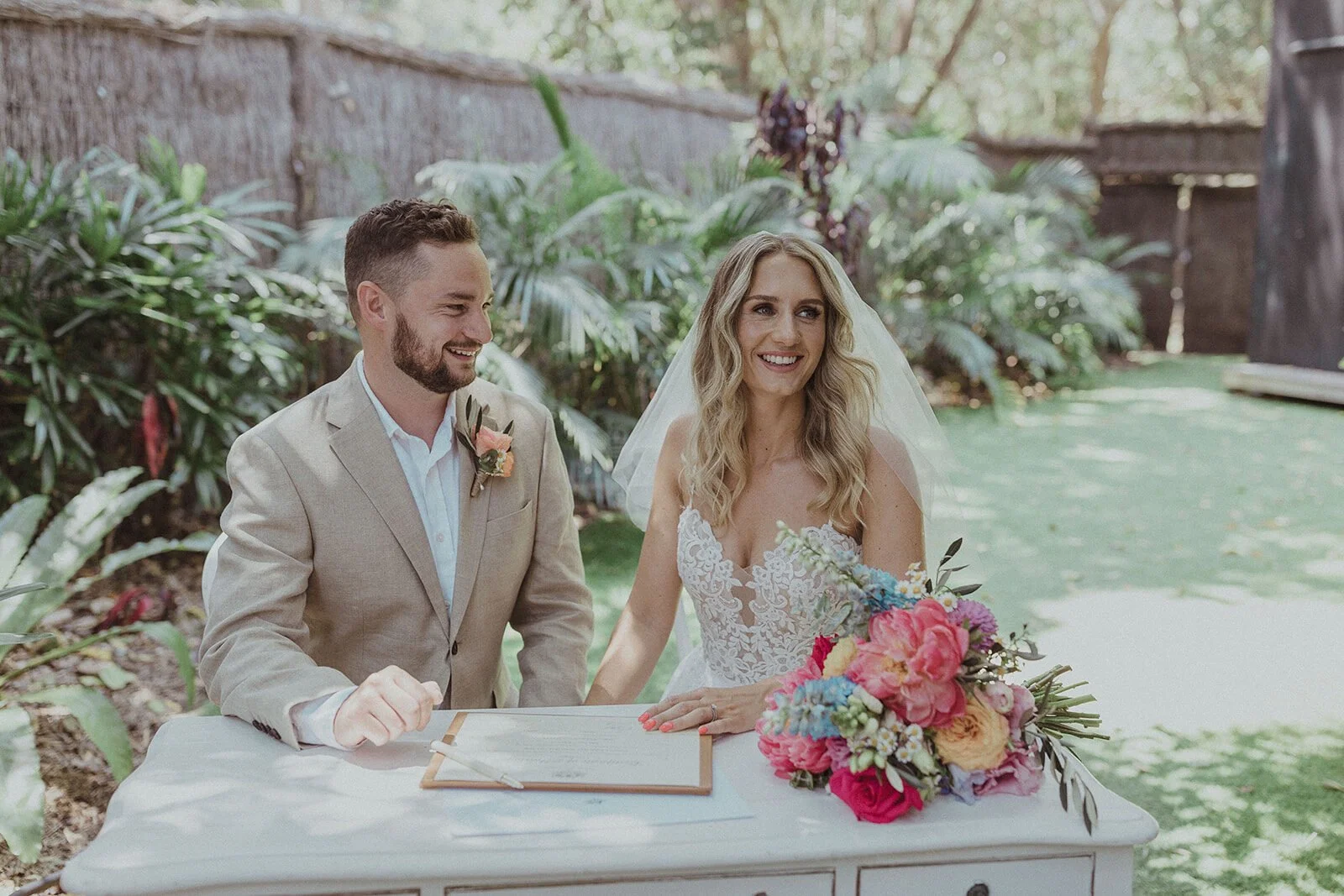 Couple signing the marriage register at a white desk, Eliza and Greg's elopement at Broken Head, Byron Bay