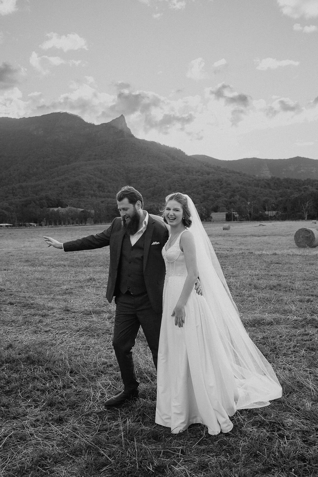 Black and white of the couple laughing in the field, Sam and Tom's elopement at Highfield Farm, Northern Rivers