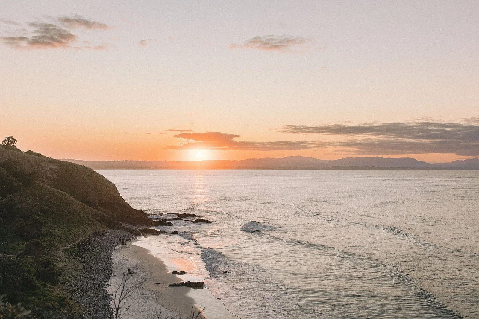 Sunset over the ocean and coastline, Abby and James' elopement at Little Wategos Beach, Byron Bay