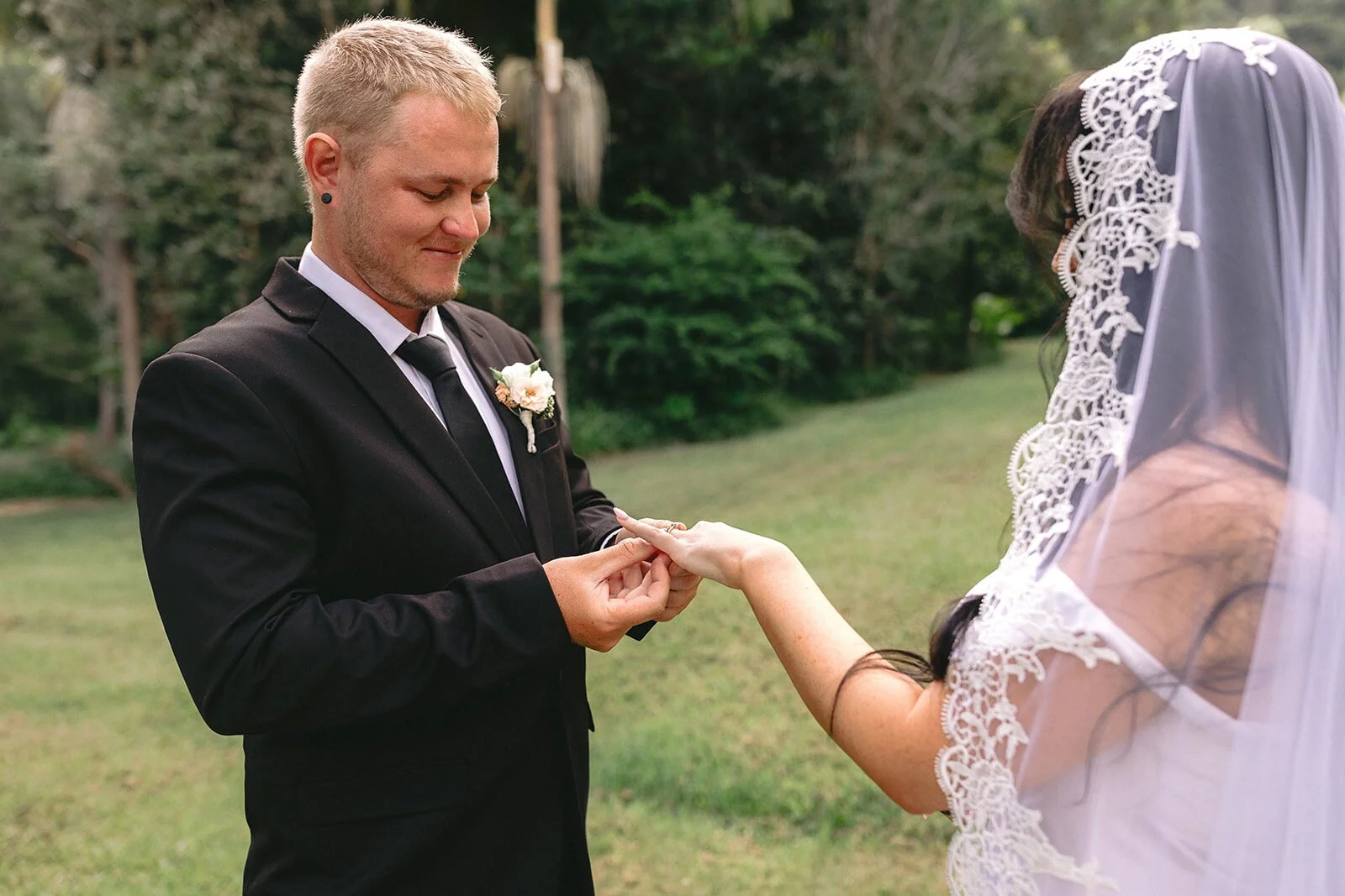 Groom placing the ring on the bride's finger, Kobi and Darren's elopement at Butterfly Lane, Byron Bay hinterland