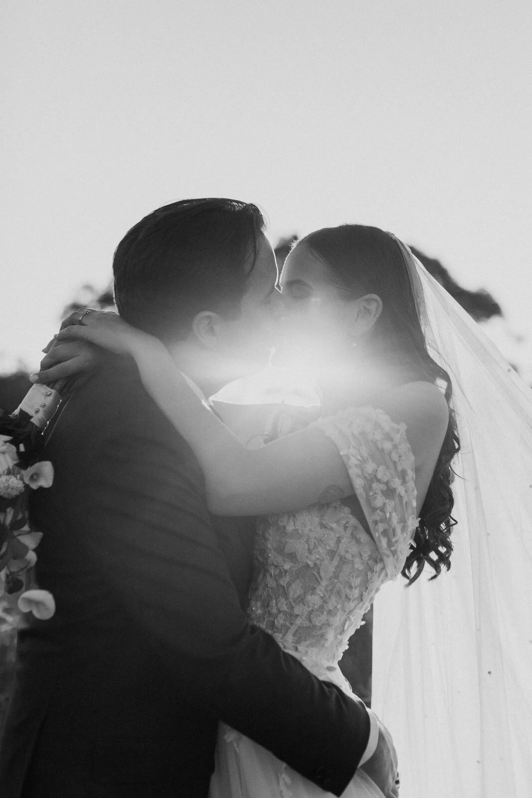 Black and white of the couple embracing, Steph and William's wedding at Earth House, Byron Bay
