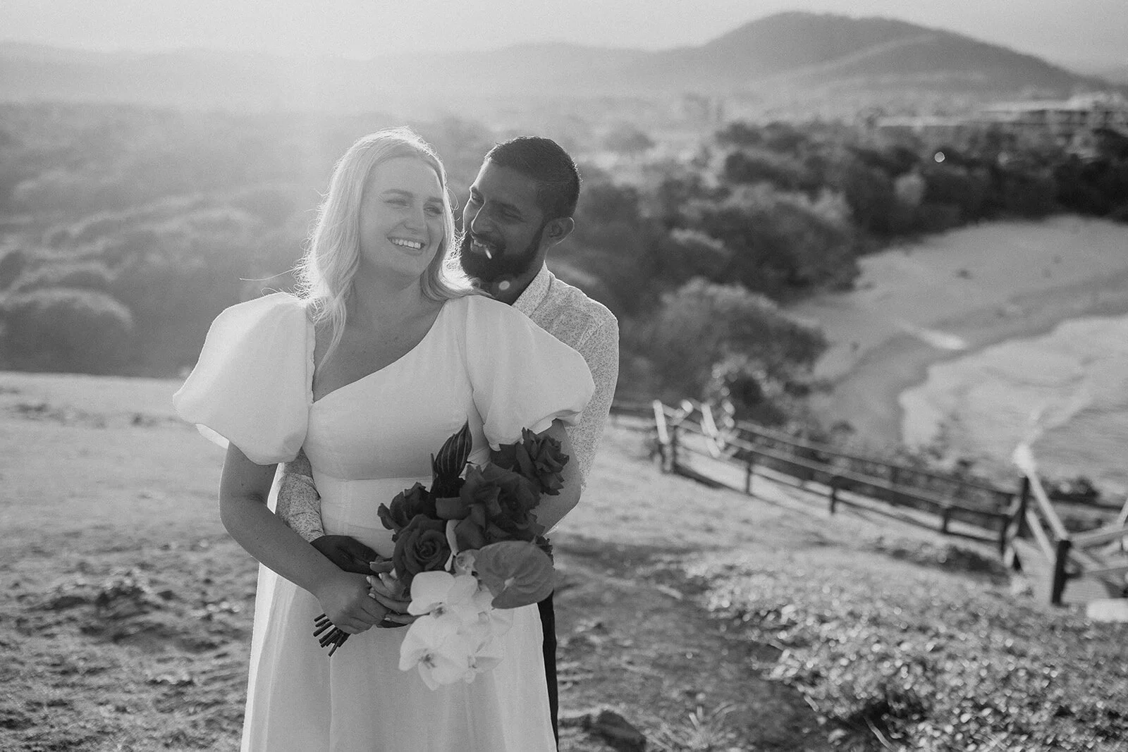 Black and white of the couple laughing together on the headland, Brittany and Mark's elopement at Cabarita Beach, Northern Rivers