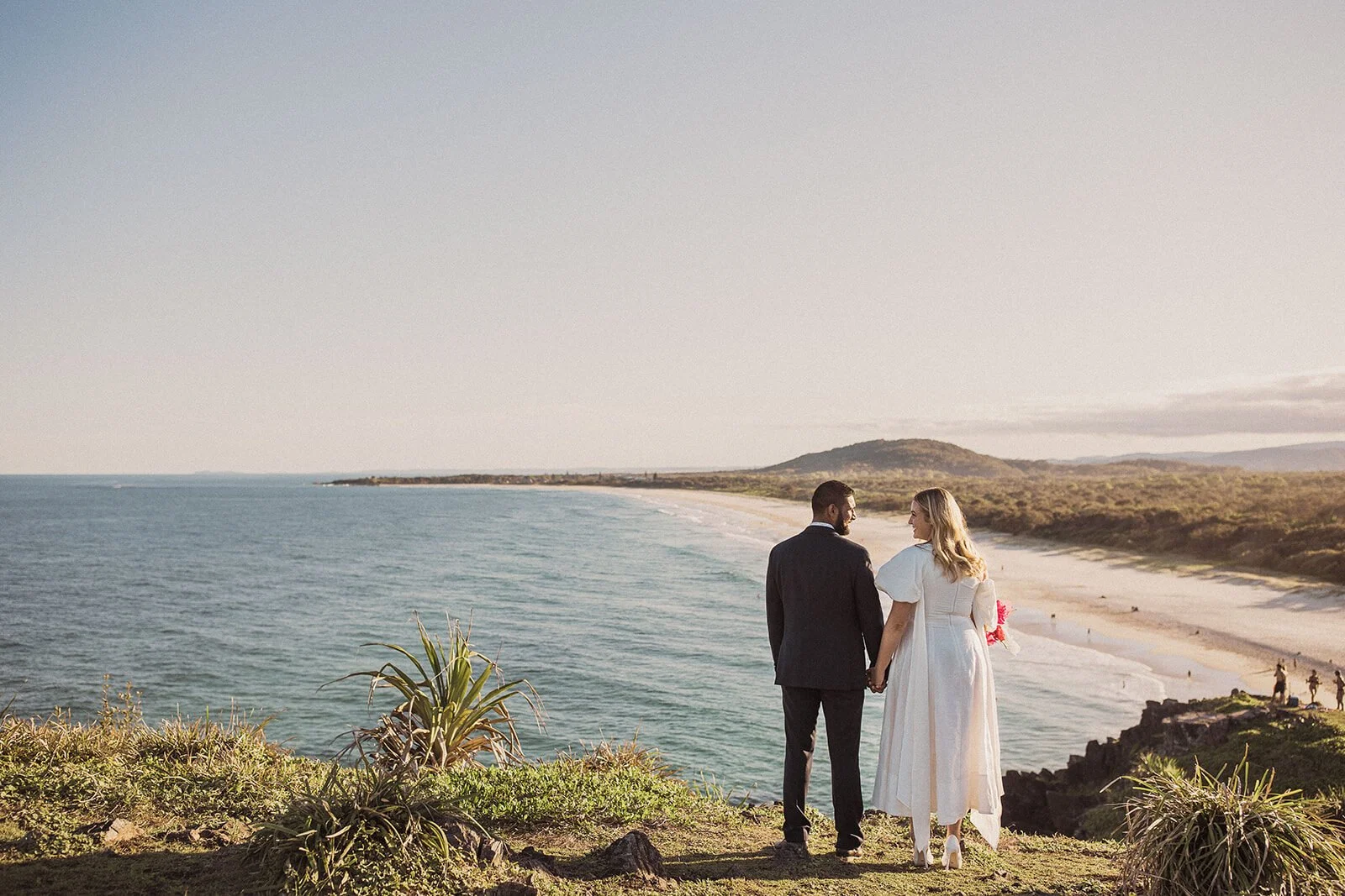 Couple from behind looking out to the ocean, Brittany and Mark's elopement at Cabarita Beach, Northern Rivers