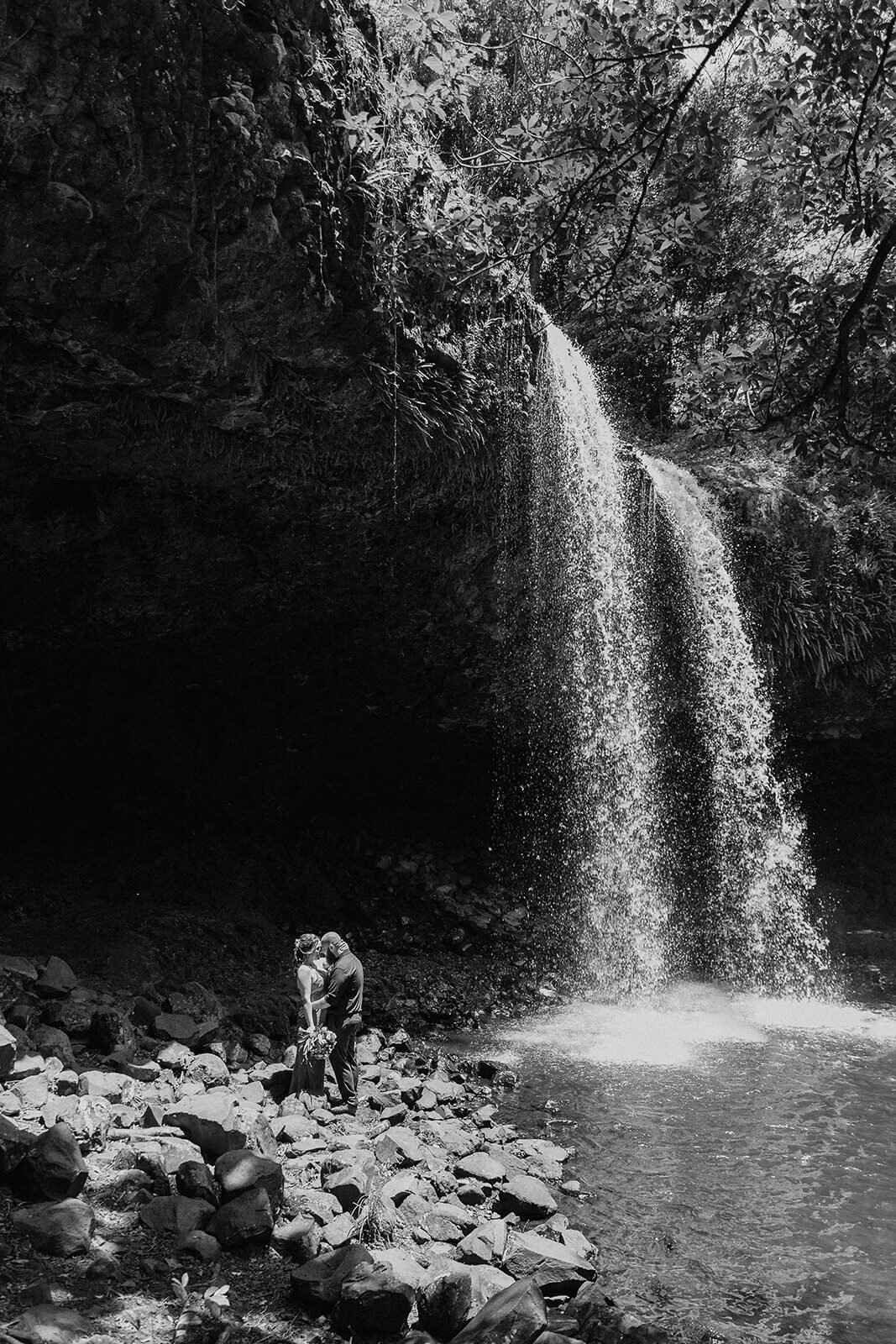 Black and white of the couple at the foot of the falls, Sara and Graeme's elopement at Killen Falls, Northern Rivers