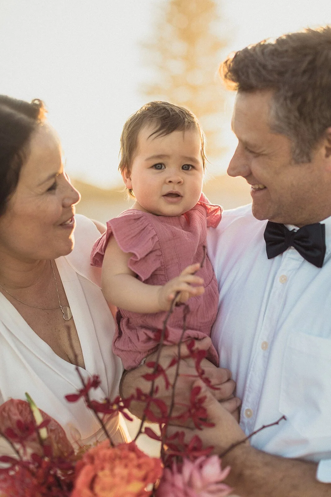 Baby smiling in a parent's arms, Maritess and Mark's elopement at Lennox Head