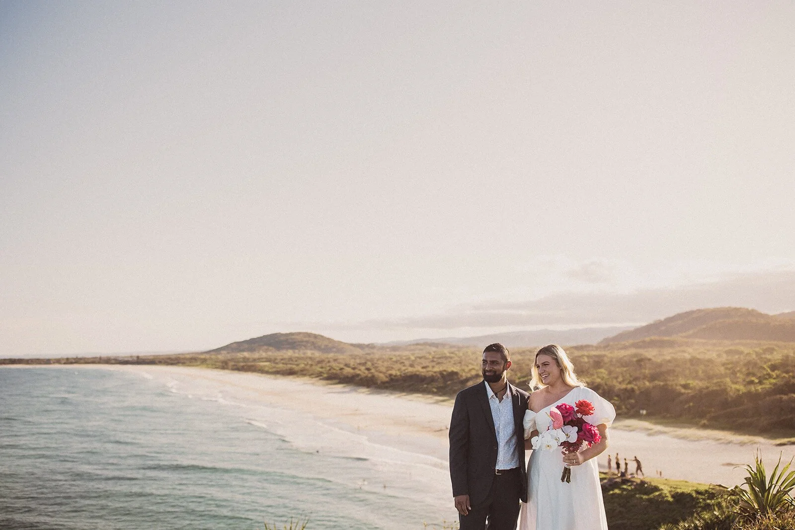 Couple standing on the headland with the long beach behind, Brittany and Mark's elopement at Cabarita Beach, Northern Rivers