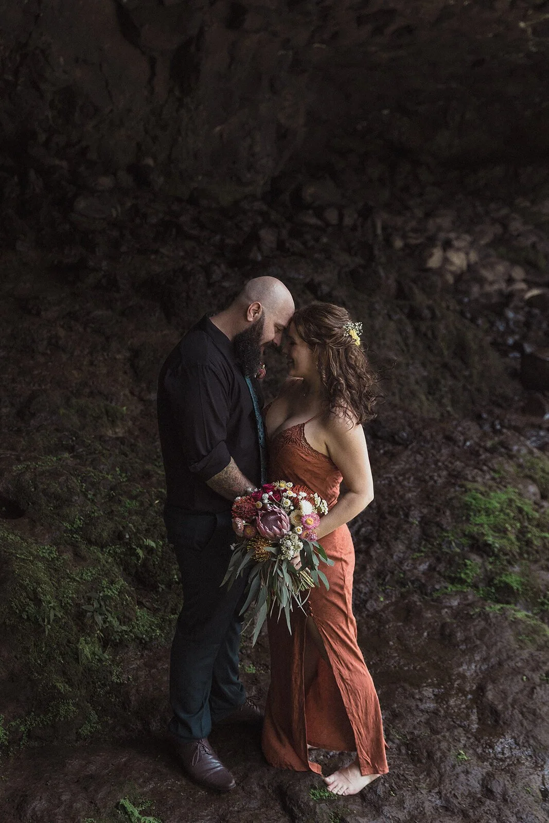 Couple embracing in a dark rock cave, Sara and Graeme's elopement at Killen Falls, Northern Rivers