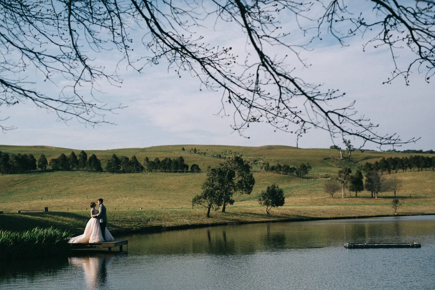 Bride and groom by the lake at Bendooley Estate in the Southern Highlands