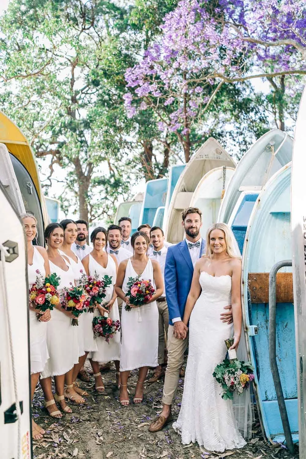 Bridal party in front of colourful surf boats at Bilgola Surf Club