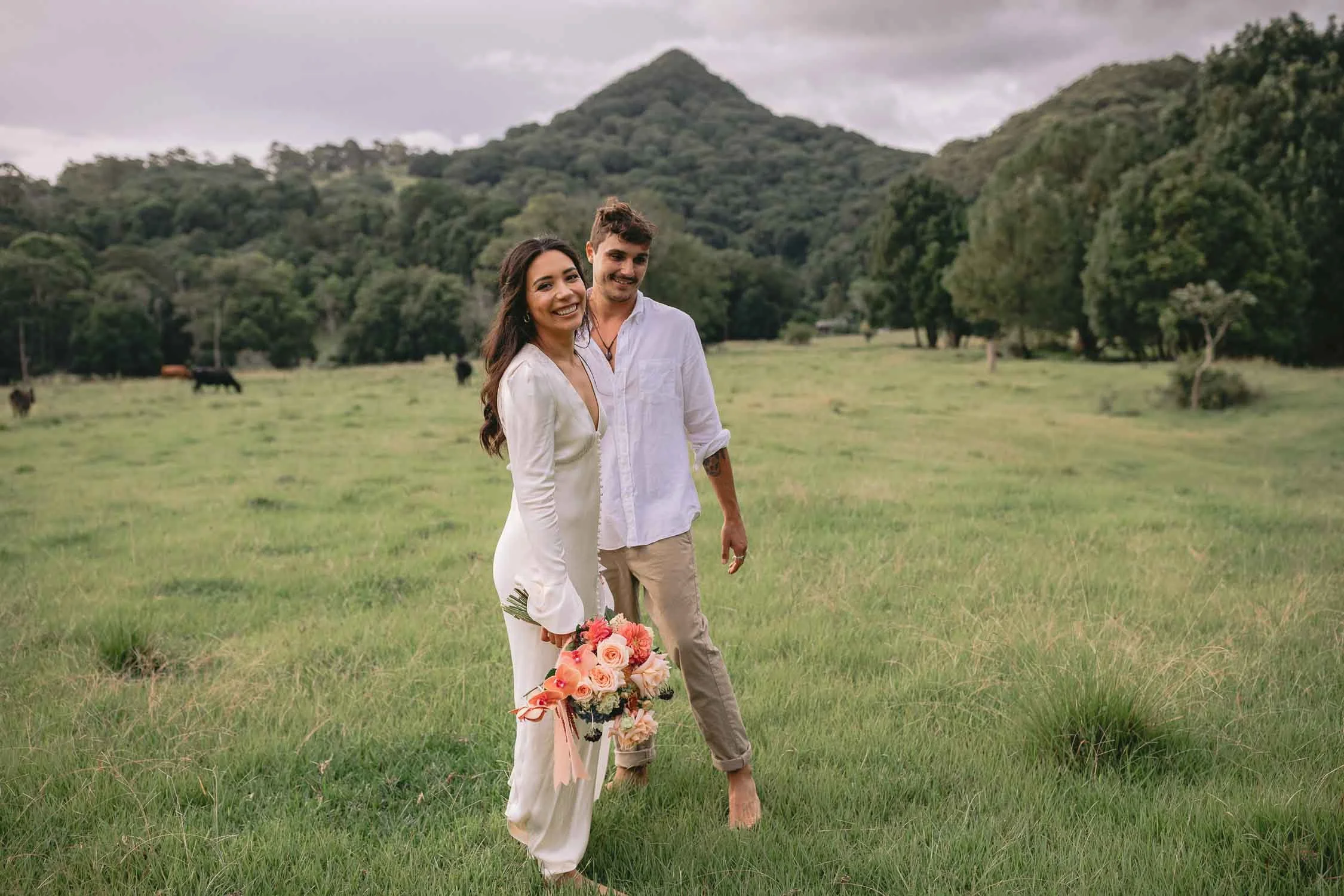 Bride and groom laughing on their weekday elopement beneath Mount Chincogan, Byron hinterland