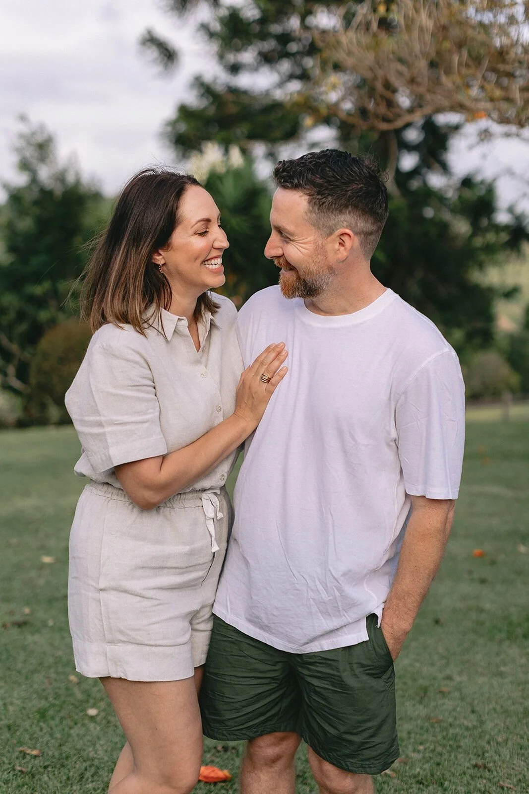 Couple embracing and smiling at each other on the lawn