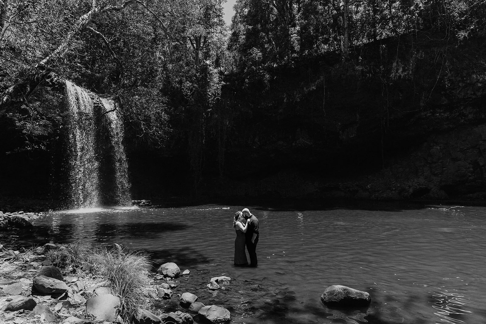 Black and white of the couple embracing at the pool, Sara and Graeme's elopement at Killen Falls, Northern Rivers