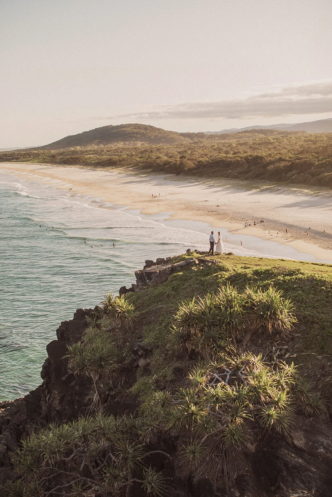 Couple on the cliff point above the waves with a wide coastal view, Brittany and Mark's elopement at Cabarita Beach, Northern Rivers