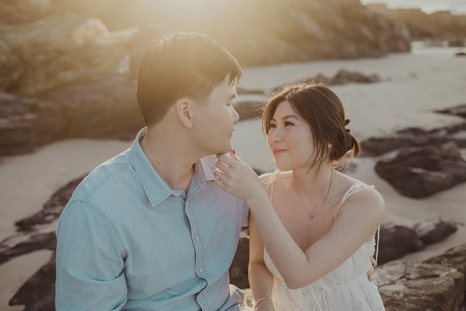 Couple laughing close together on the beach, Maggie and William's pre-wedding photos in Byron Bay