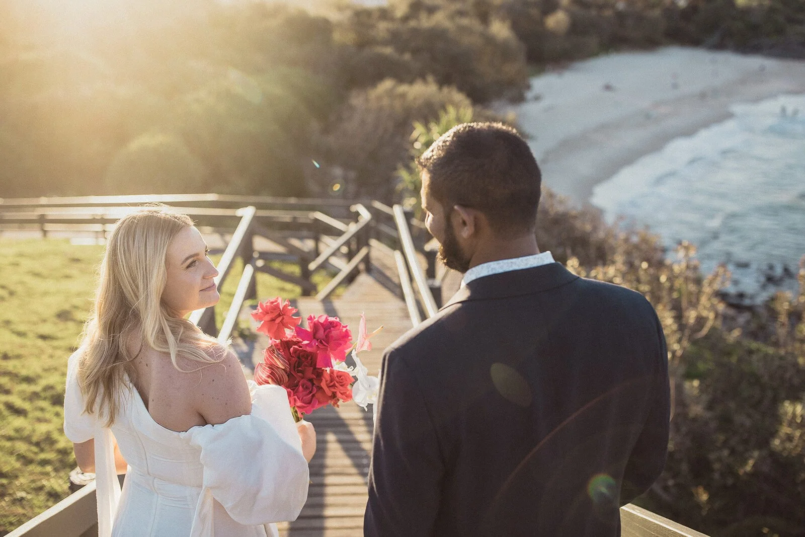 Couple on the wooden stairs in warm backlight, Brittany and Mark's elopement at Cabarita Beach, Northern Rivers