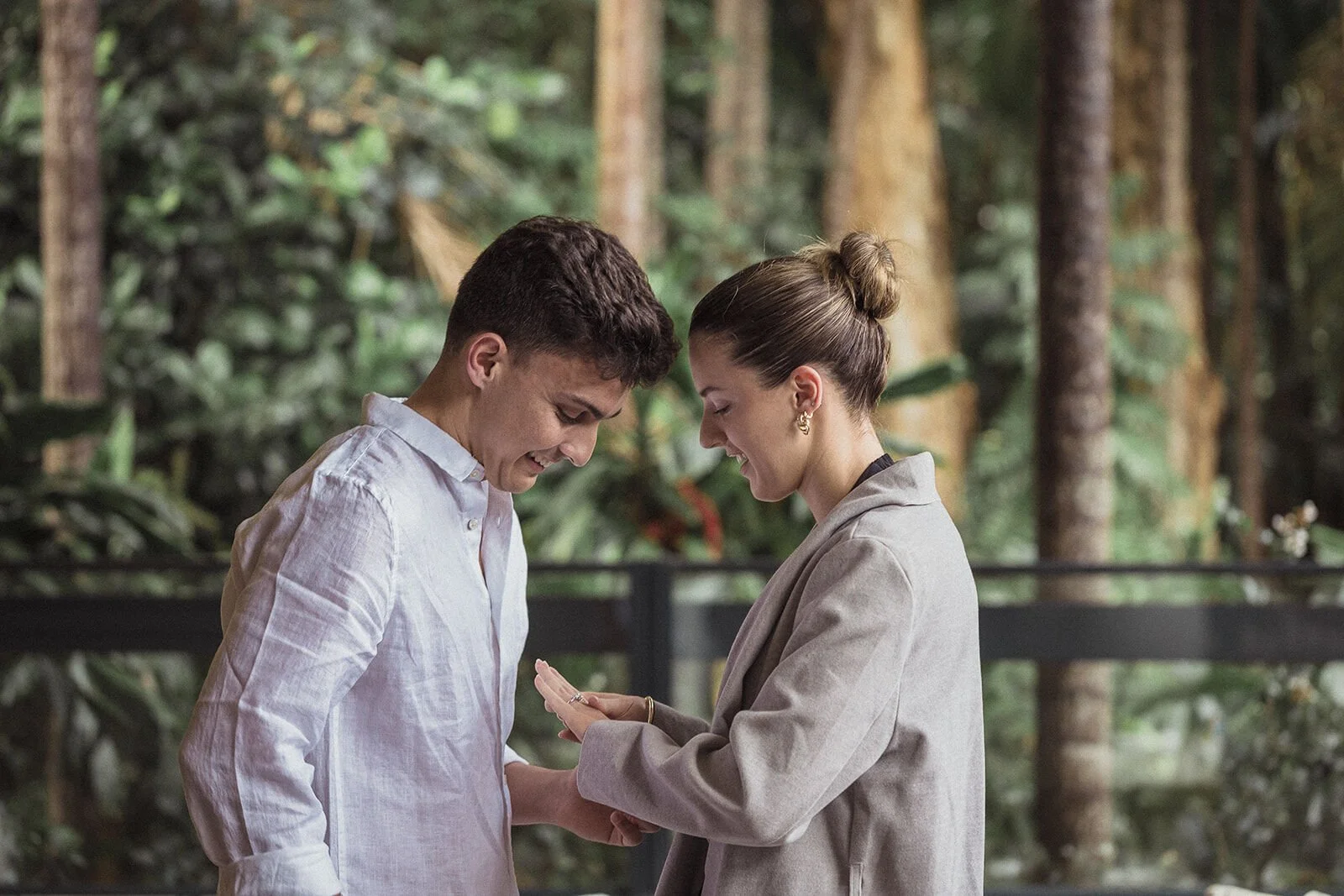Couple looking down at the ring on her hand, Ben and Chloe's marriage proposal in Byron Bay