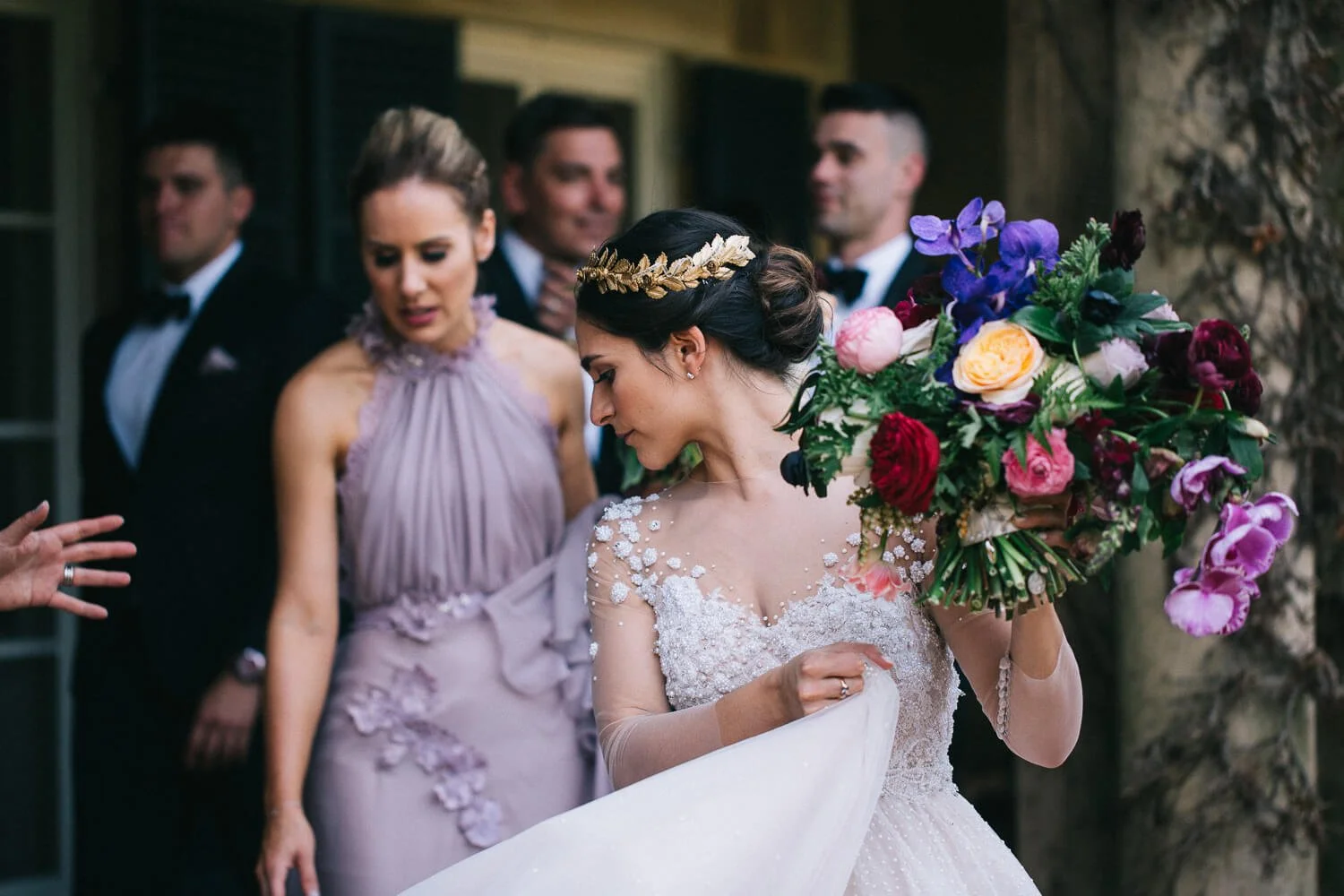 Bride with her bridal party and a bold bouquet of roses and anemones at Bendooley Estate
