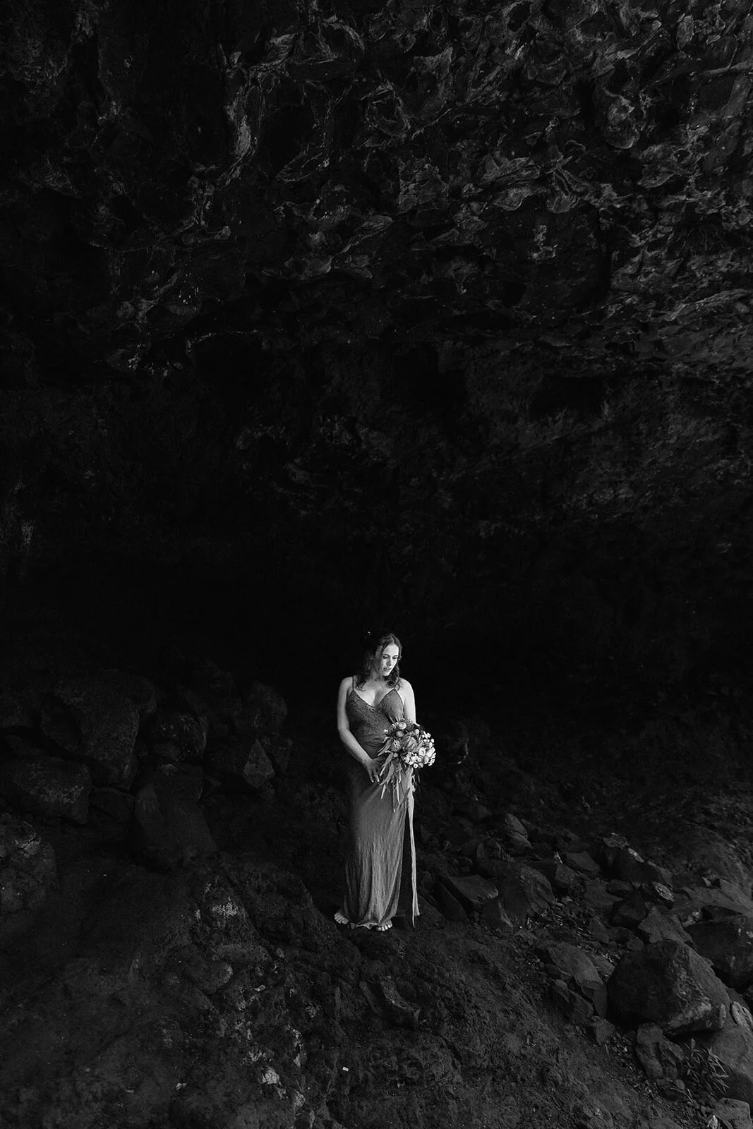 Black and white of the bride in the cave, Sara and Graeme's elopement at Killen Falls, Northern Rivers