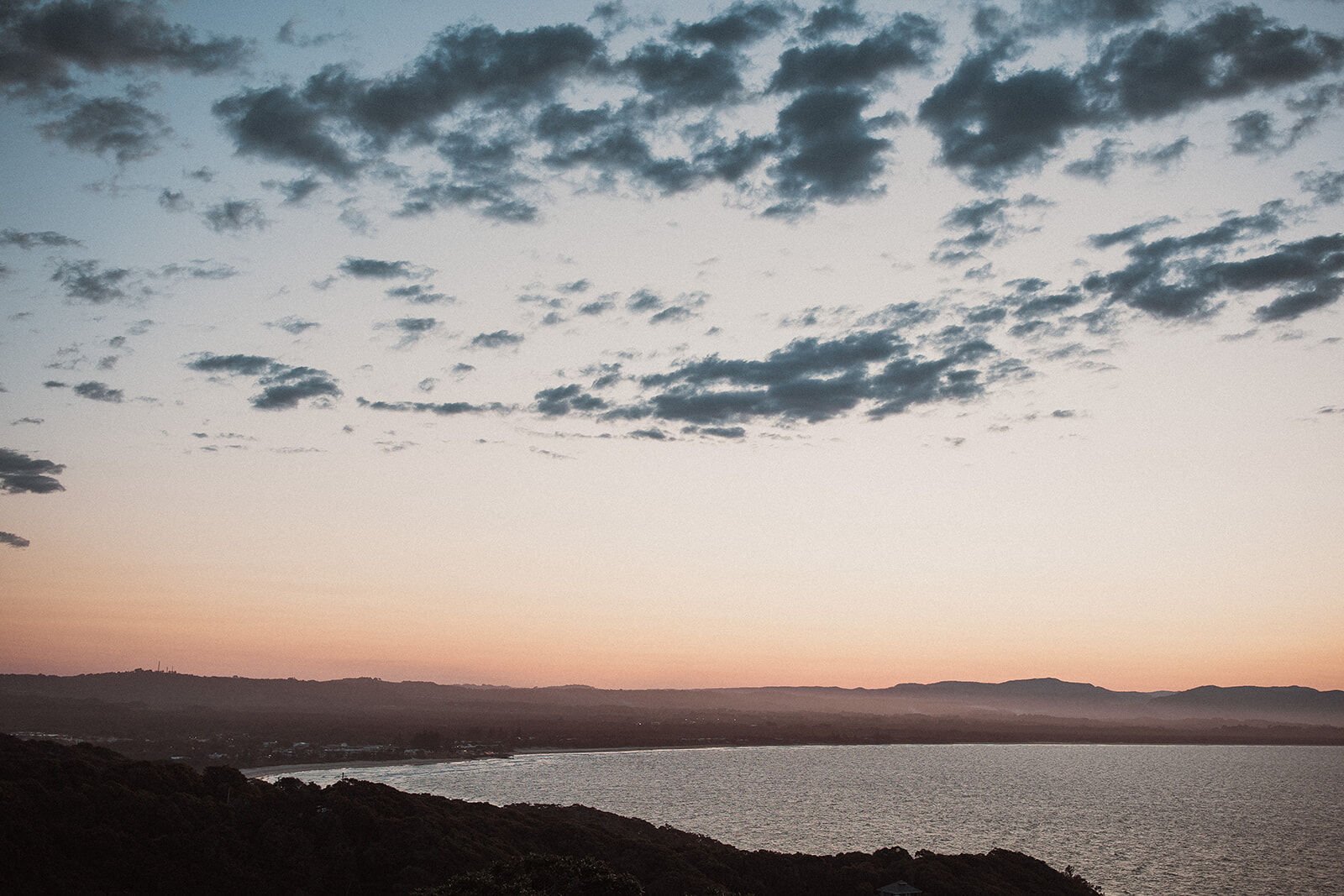 Dusk sky over the bay and coastline from Cape Byron, Douglas and Ying's sunset marriage proposal at Cape Byron Lighthouse, Byron Bay