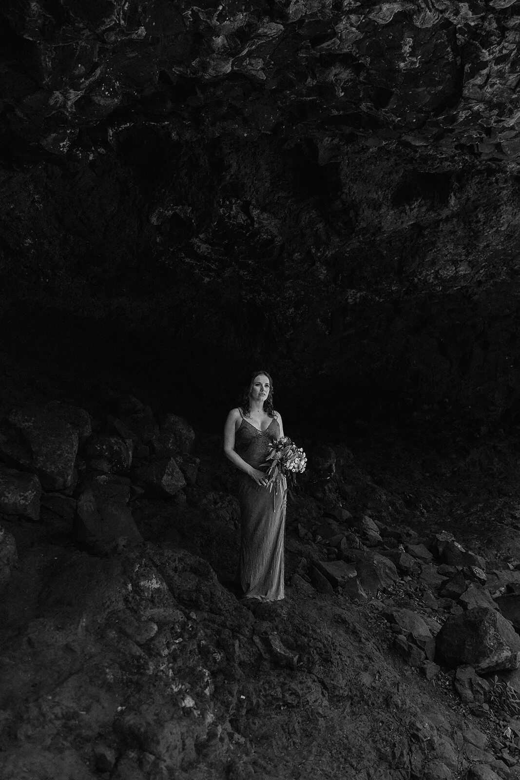 Black and white of the bride in the cave, Sara and Graeme's elopement at Killen Falls, Northern Rivers
