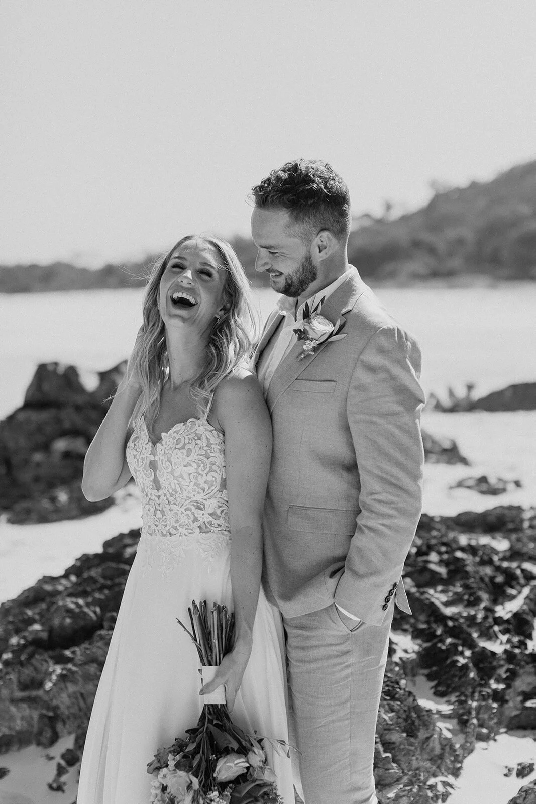 Black and white of the couple laughing on the beach, Eliza and Greg's elopement at Broken Head, Byron Bay