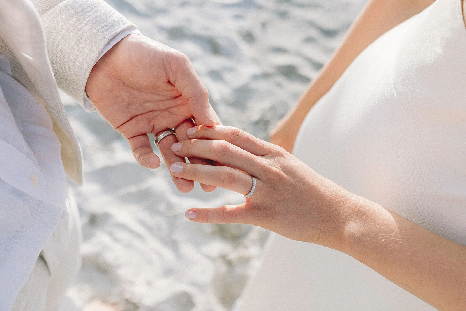 Close up of the couple's hands and the wedding ring, Abby and James' elopement at Little Wategos Beach, Byron Bay