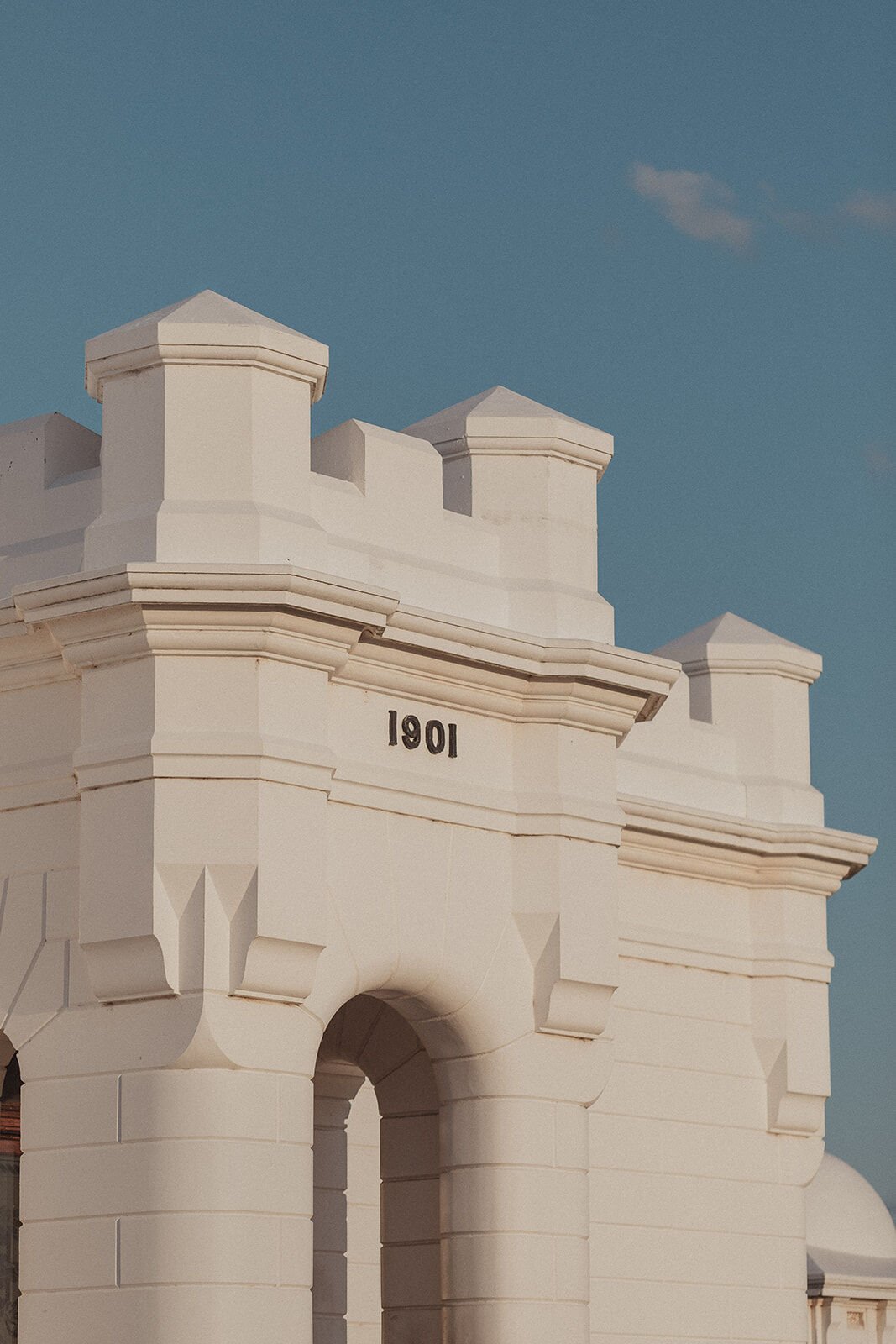 Detail of the lighthouse keeper's building dated 1901 against a blue sky, Douglas and Ying's sunset marriage proposal at Cape Byron Lighthouse, Byron Bay