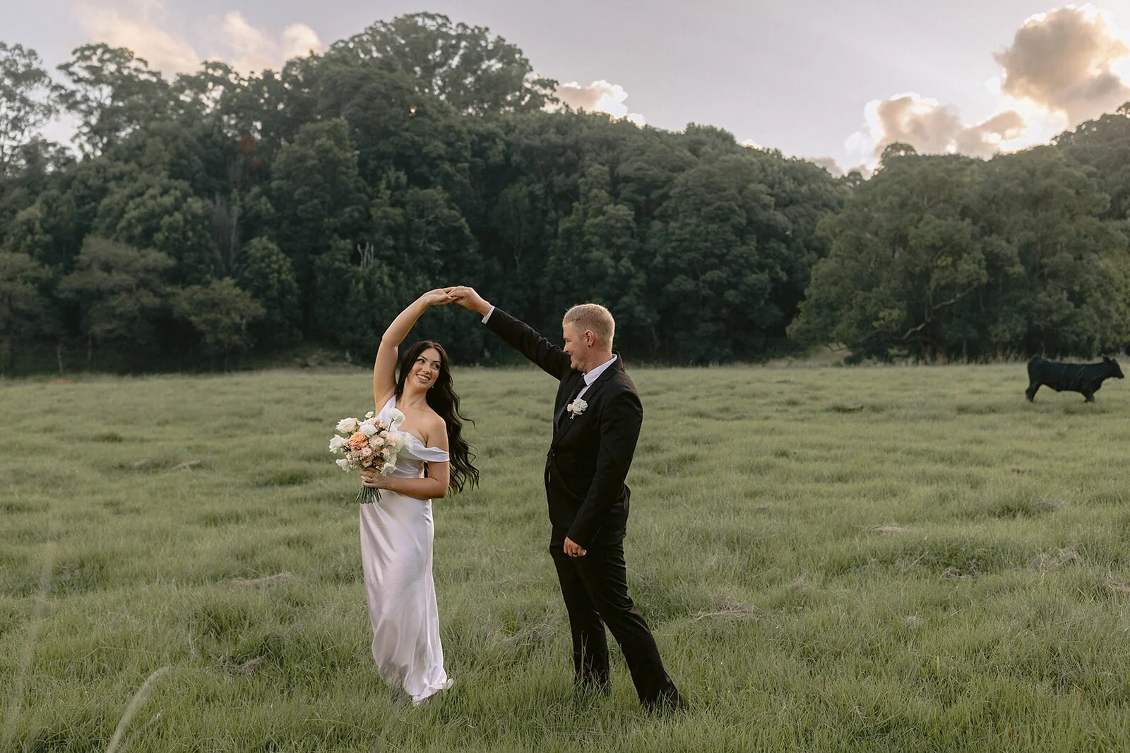Groom twirling the bride in the paddock, Kobi and Darren's elopement at Butterfly Lane, Byron Bay hinterland