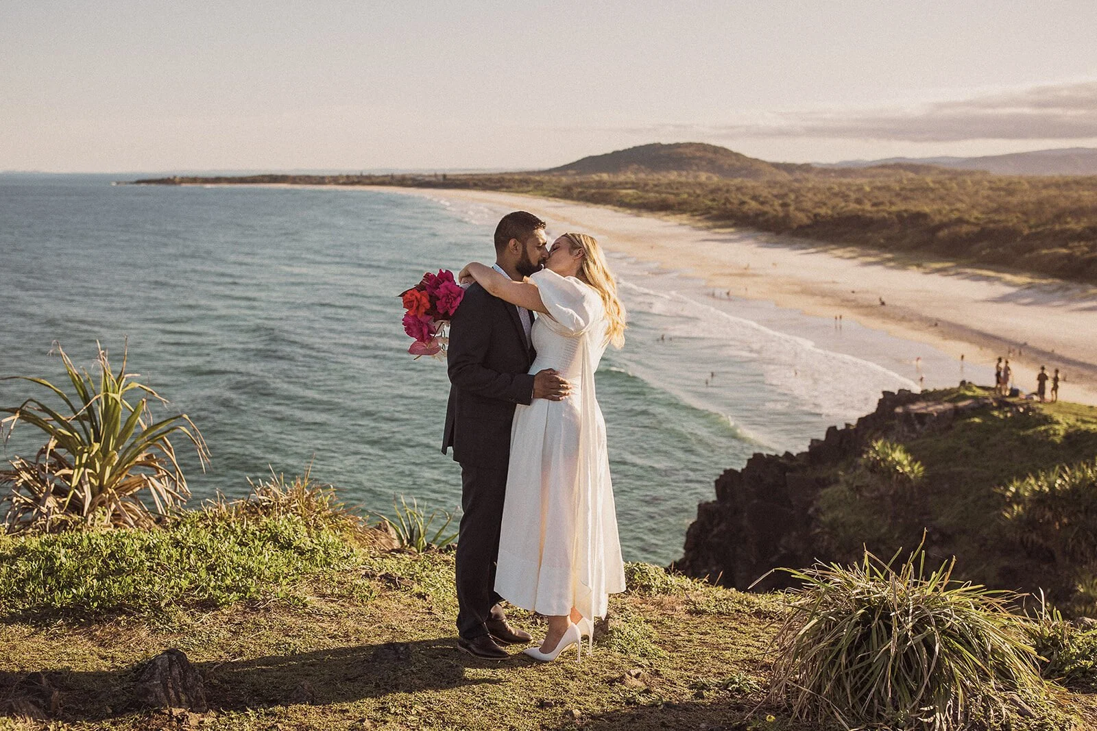 Couple embracing on the cliff edge above the sea, Brittany and Mark's elopement at Cabarita Beach, Northern Rivers