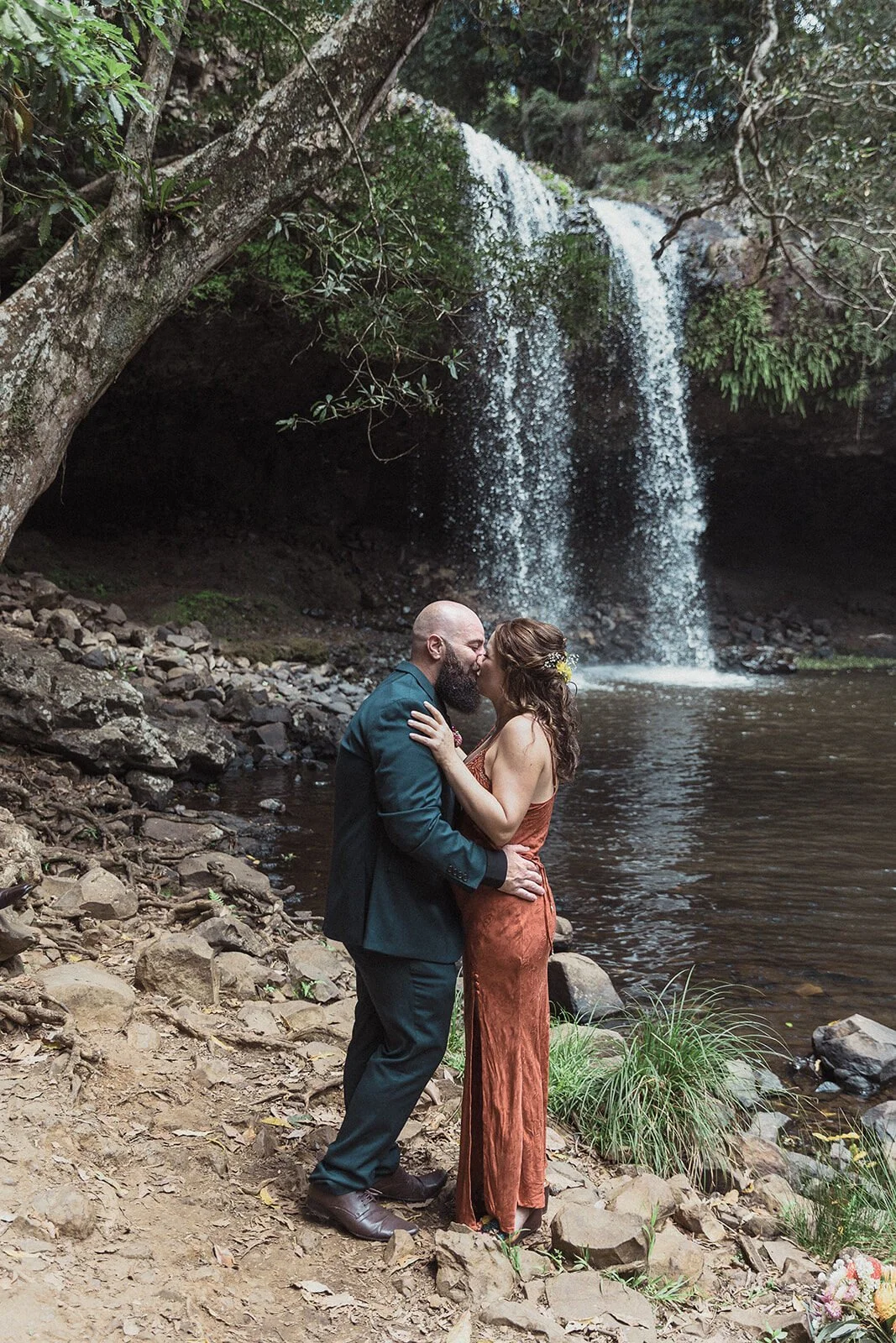Couple embracing beside the falls, Sara and Graeme's elopement at Killen Falls, Northern Rivers