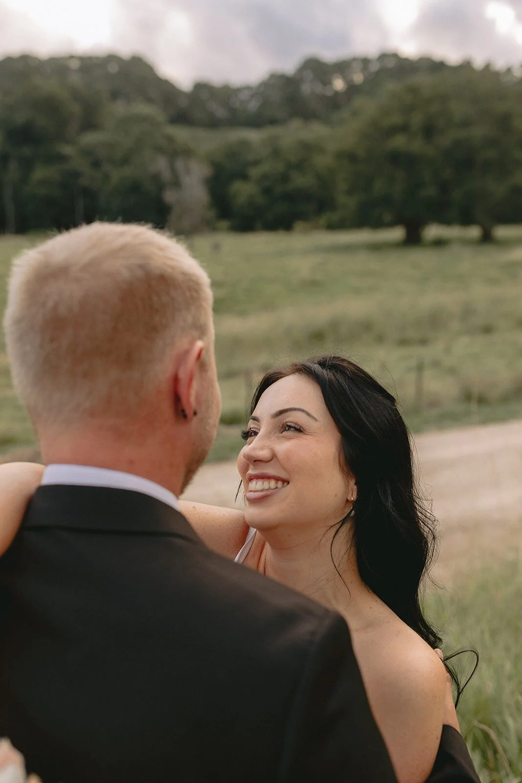 Bride smiling up at the groom, Kobi and Darren's elopement at Butterfly Lane, Byron Bay hinterland