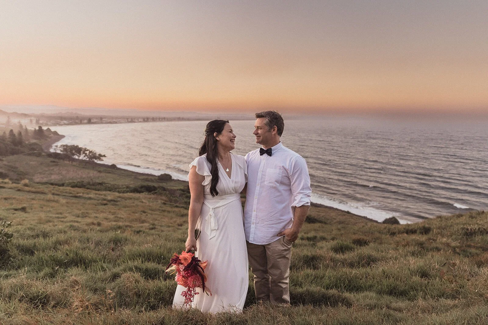 Couple smiling on the headland above the ocean, Maritess and Mark's elopement at Lennox Head